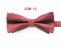 Wine red textured men's bow tie detail shot showcasing fabric and formal design features. - Burgundy