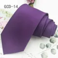 Detailed close-up view of a purple solid tie neatly rolled on botanical background. - Purple