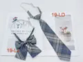 Detail shot of Japanese JK uniform plaid tie and bow set in blue gray grid pattern. - Bow Tie / No. 19