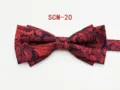 Detailed close-up of red and navy paisley patterned double bow tie, elegant formal accessory. - Paisley