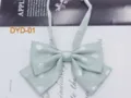 Close-up detail of light green polka dot bow tie, double layer JK uniform neck accessory. - DYD-01