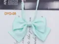 Close-up detail of light blue polka dot bow tie, JK uniform collar accessory fabric design. - DYD-05