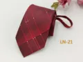 Detail view of the men's burgundy plaid zipper tie, showing texture and precise width. - LN-21