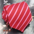 Red striped men's necktie detail close-up view, elegant jacquard woven polyester fabric. - Red White Pink Stripe (HCD-25)