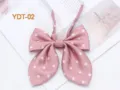Close-up detail of cute pink polka dot bow tie accessory, soft fabric texture and clean flat lay. - Cherry Pink