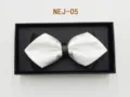 Detail shot of a stylish black and white bow tie in a black gift box, perfect for formal wear. - Black and White Color Block (NEJ-05)