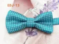 Close-up detail of a turquoise blue polka dot bow tie featuring double layer fabric. - EDJ-13 Cyan-Blue with White Dots