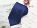 Detail shot of men's business striped necktie in dark blue, showcasing fine woven fabric texture. - CN-23