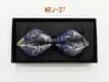 Closeup of a blue paisley patterned bow tie in a black gift box, elegant design detail. - Blue and Gold Paisley (NEJ-27)