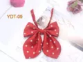 Close-up detail of the red polka dot JK bow tie, showcasing smooth fabric texture and cute design. - Bright Wine Red