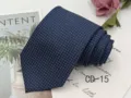 Detail view of men's navy blue jacquard tie with white micro polka dot pattern. - CD-15
