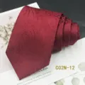 Detail shot of red jacquard paisley men tie, showing premium fabric texture and folded design. - C02N-12