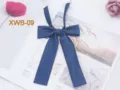 Detail shot of navy blue twill JK uniform bow tie, featuring elegant long ribbon straps. - Navy Blue