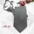 Detail view of men's business grey necktie featuring elegant yellow geometric jacquard pattern. - L9D-01