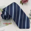 Detail shot of classic navy blue men's necktie featuring white and light blue diagonal stripes. - CDT-06