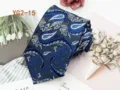 Detailed close-up of blue and grey paisley pattern silk tie fabric texture and fine weaving. - YG2-15