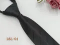 Close-up detail of the black striped zipper tie, showing the fabric texture and structure. - L6L-01