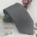 Close-up detail shot of a classic black and grey patterned mens business tie with delicate weave. - CDT-13