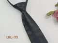 Detail view of dark grey plaid narrow zipper necktie, featuring convenient design. - L6L-33