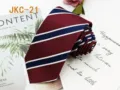 Classic striped necktie detail shot, showing burgundy fabric and blue white diagonal pattern. - JKC-21