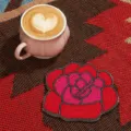 Handmade beaded rose coaster detail shot, elegant red and pink floral design for table decor. - Red Floral / White