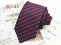 Detailed view of a classic red and blue striped JK uniform necktie, handmade 7cm style. - JKC-36