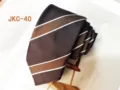 Brown striped tie detail view, classic design, textured fabric, apparel accessory. - JKC-40
