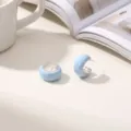 Detailed close-up of light blue chunky hoop earrings with a stylish marble enamel finish. - Light Blue C-Shaped Copper Earrings
