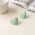 Mint green heart stud earrings close-up detail, elegant minimalist resin daily jewelry accessory. - Stainless Steel Mint Green Heart Stud Earrings