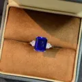 Close-up detail of a royal blue sapphire rectangular sterling silver ring in velvet box. - Size 5 / Classic Three-Stone Style (PYJZ032)