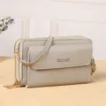 Grey multi-compartment women crossbody bag with front flap pocket and adjustable shoulder strap. - Gray