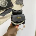 Sac à bandoulière noir chic avec nœud et chaîne de perles, sac compact élégant pour le bureau. - Noir