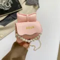 Sac à bandoulière mini rose pour femmes avec nœud élégant, poignée perle et chaîne chic. - Rose