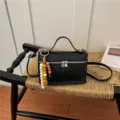 Chic black woven vanity handbag and stylish casual crossbody bag for women daily commute. - With Pendant / Black