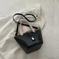Black and pink bucket bag, stylish shoulder bag with lock closure and top handle, casual design. - Black & Pink