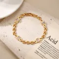 Elegant gold-tone metal chain bracelet featuring sparkling rectangular zirconia stones. - Square Zirconia Style
