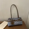 Casual denim shoulder bag with brown straps and star charm, chic retro cross-body design. - Blue
