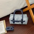 Stylish denim bowling bag with dark blue leather handles and crossbody strap for daily use. - No Pendant / Blue