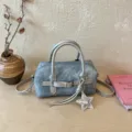Stylish light blue denim barrel bag with star charm, chic shoulder and crossbody design. - With Pendant / Silver
