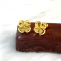 Close-up of exquisite gold frosted four-leaf clover stud earrings showing fine metal texture. - Frosted Windmill Clover / Gold