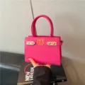 Bright pink fashion shoulder bag for women with gold hardware and top handles style 2026 - Red