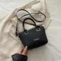 Black woven bucket bag with knot handle and crossbody strap for beach daily casual use - Black