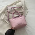 Pink woven bucket bag with stylish knot top handles and shoulder strap for women beach summer. - Pink