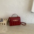Stylish women handbag with metal clasp and unique round button decor for daily wear. - Red