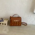 Brown women shoulder handbag with unique circular buttons decor and metallic clasp, stylish design. - Brown