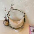 Straw woven crescent shoulder bag with green trim and wide strap, stylish casual hobo purse. - Green