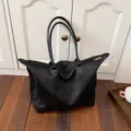 Black large capacity travel tote bag, durable nylon fabric with leather handles, casual style. - Black