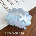 Beautiful seashell and starfish hair claw detail shot, elegant acrylic styling for women. - Blue