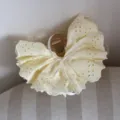 Close-up detail of the sweet light yellow eyelet lace hair claw clip with white ribbon bow. - Hemline Claw Clip / 10cm / Yellow