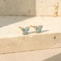 Gouden vlinder oorknopjes met sprankelende lichtblauwe kristallen stenen voor dames modieus. - 14k Champagne Goud Licht Zeeblauw